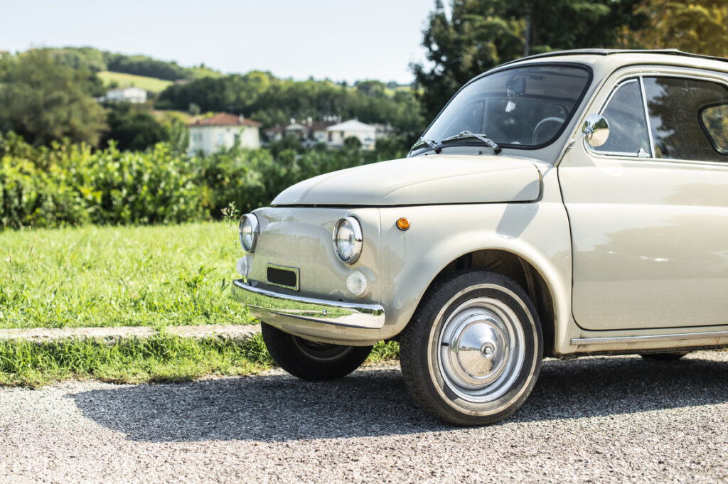 Vintage beige color car. Small old car. Italian car.