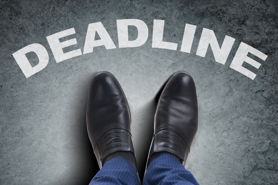Businessman feet facing tough deadline